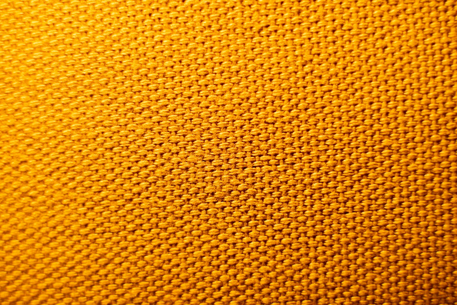 Detail crop of ripstop trousers with an articulated knee panel and exposed magenta stitching.
